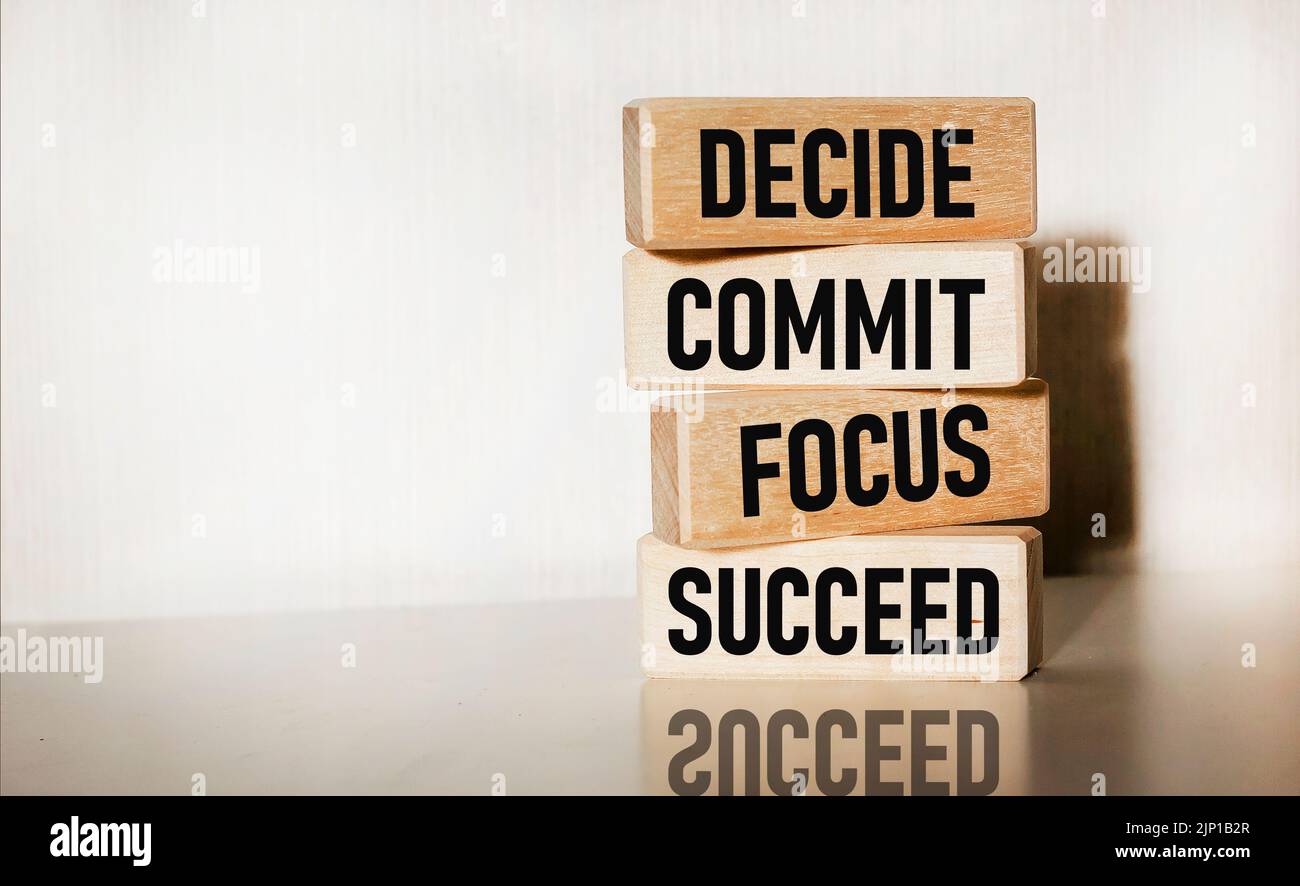 Motivational and inspirational quotes - Decide, commit, focus, succeed on wooden blocks and white background Stock Photo