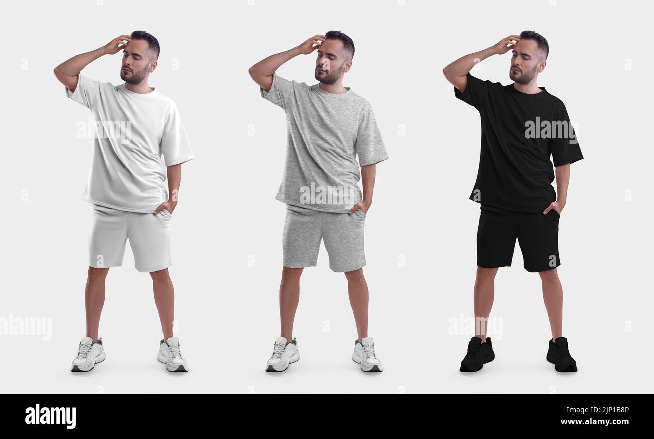 Mockup of white, black, heather oversize suit on posing guy, t-shirt, shorts on bearded man in sneakers with hand in pocket isolated on background. Ap Stock Photo