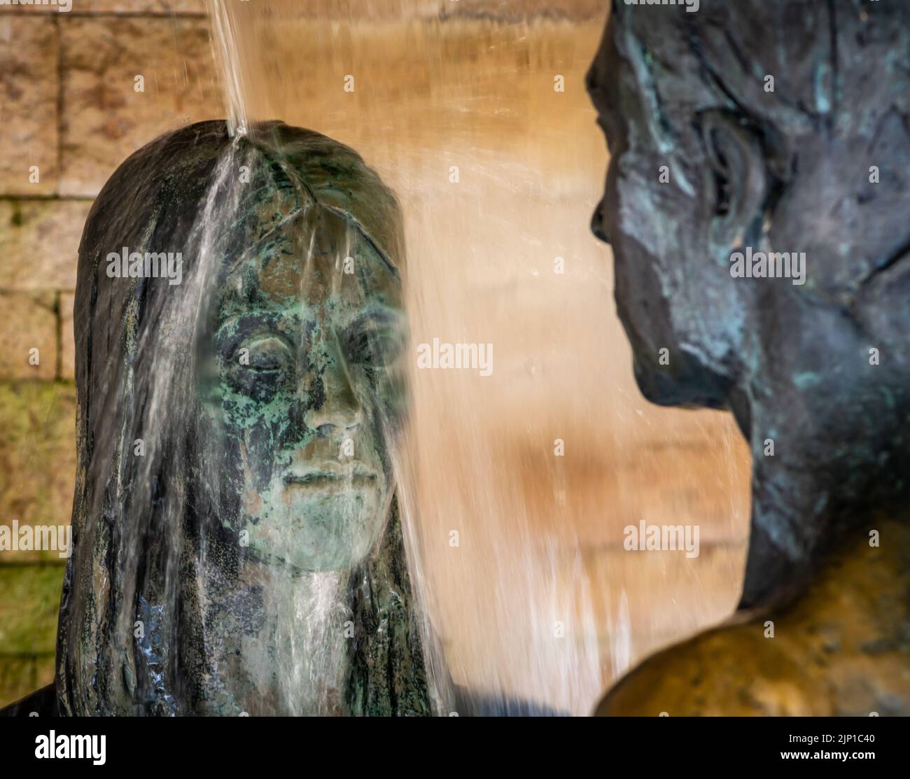 garden of love with scenic statue of man and woman in love - bronze statue - Trauttmansdorff gardens of Merano - South Tyrol, northern Italy- Meran Stock Photo