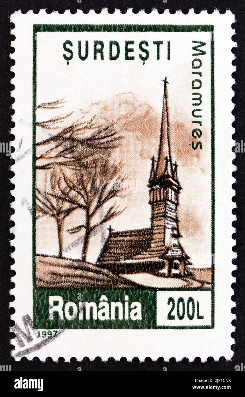ROMANIA - CIRCA 1997: A stamp printed in Romania from the 'Churches' issue shows the wooden church of Surdesti, Maramures, circa 1997. Stock Photo
