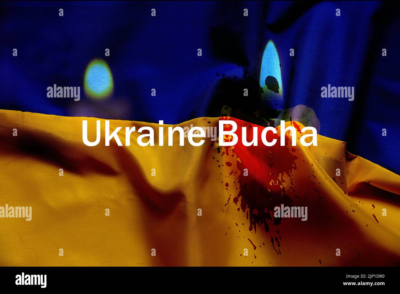 The flame of a candle against the background of the flag of Ukraine is yellow-blue, we mourn for those who died in Ukraine, the text is Ukraine, the c Stock Photo