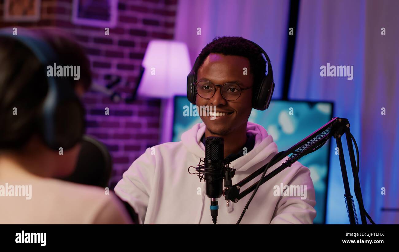 Portrait of smiling african american online radio host listening to
