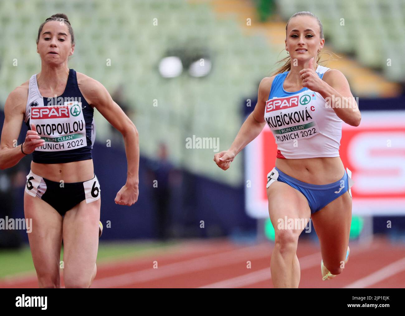 Athletics - 2022 European Championships - Olympiastadion, Munich, Germany - August 15, 2022 Cyprus' Olivia Fotopoulou and Czech Republic's Eva Kubickova in action during the Women's 100m Round 1 - Heats REUTERS/Wolfgang Rattay Stock Photo