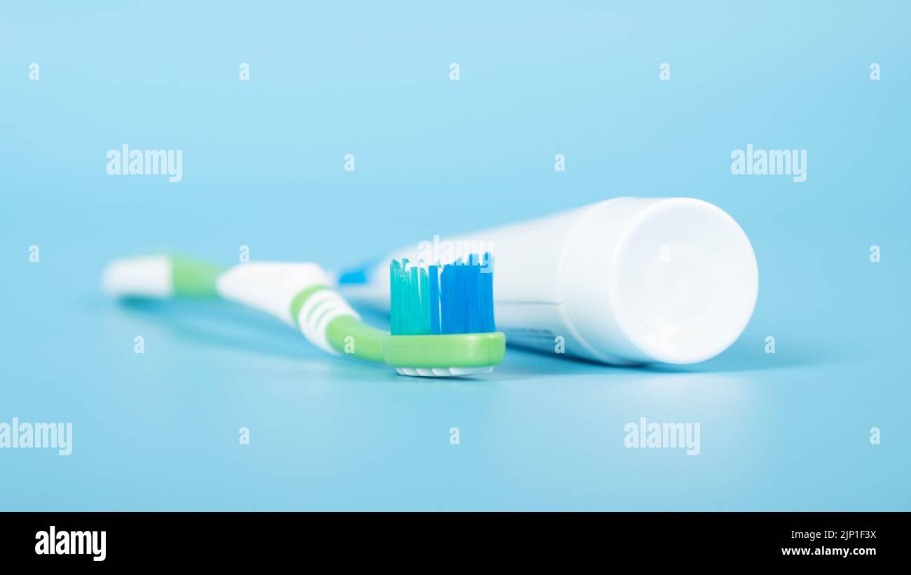 toothpaste and a toothbrush on a blue medical background, dental care