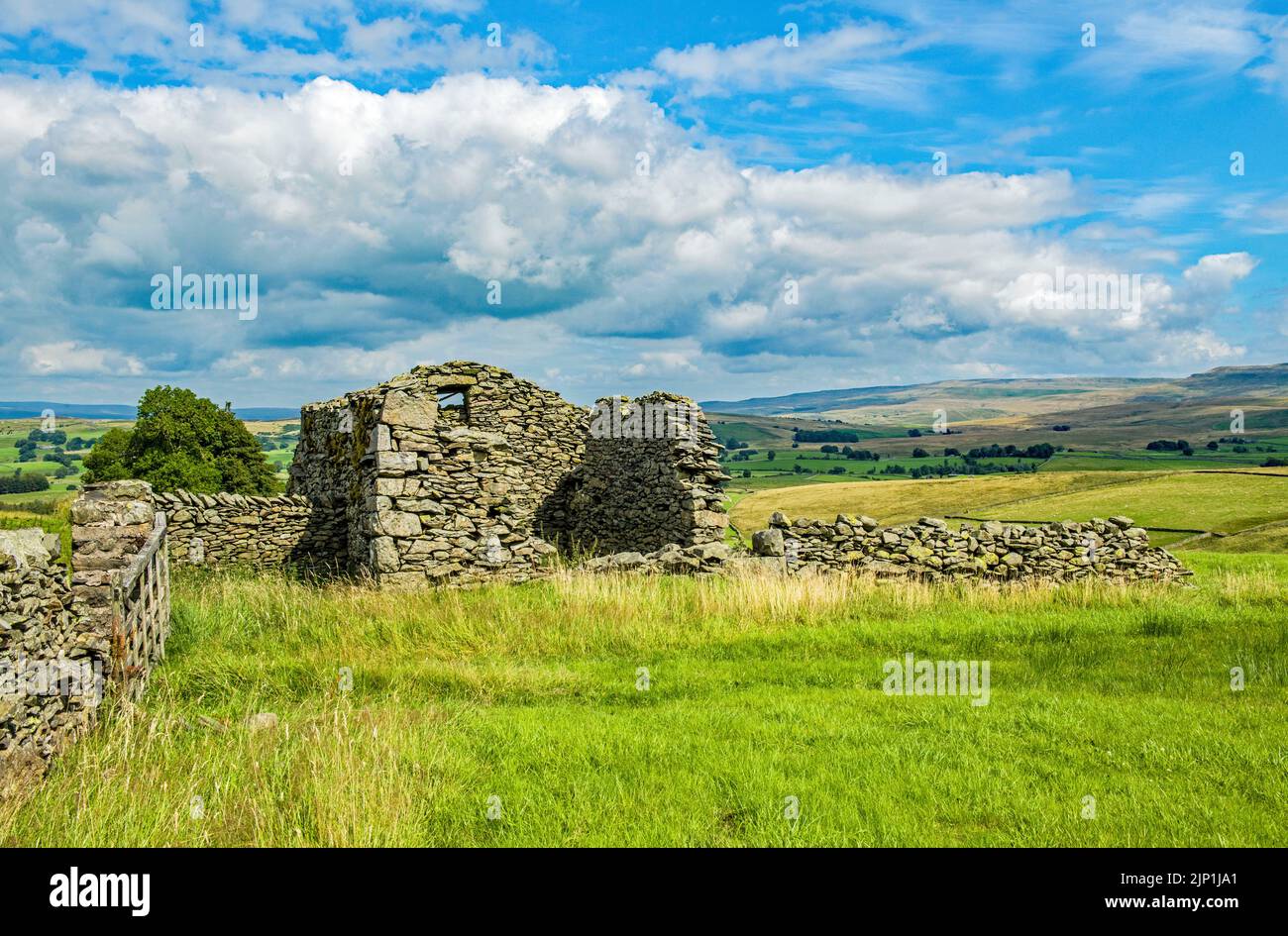 A beautiful landscape, fronted by a derelict and run down barn in the dale of Artle Garth Cumbria Stock Photo