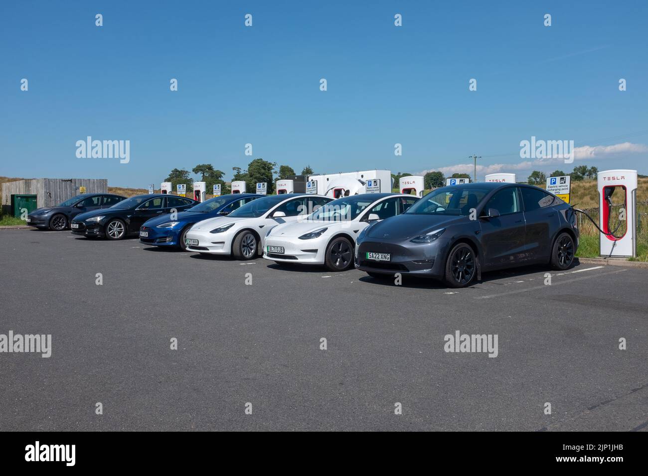 Tesla, electric cars charging at rapid charging station. Tebay Services, on M6 in United Kingdom Stock Photo