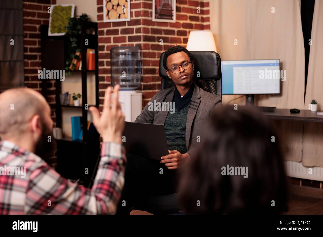 African american therapist listening to people at couple therapy