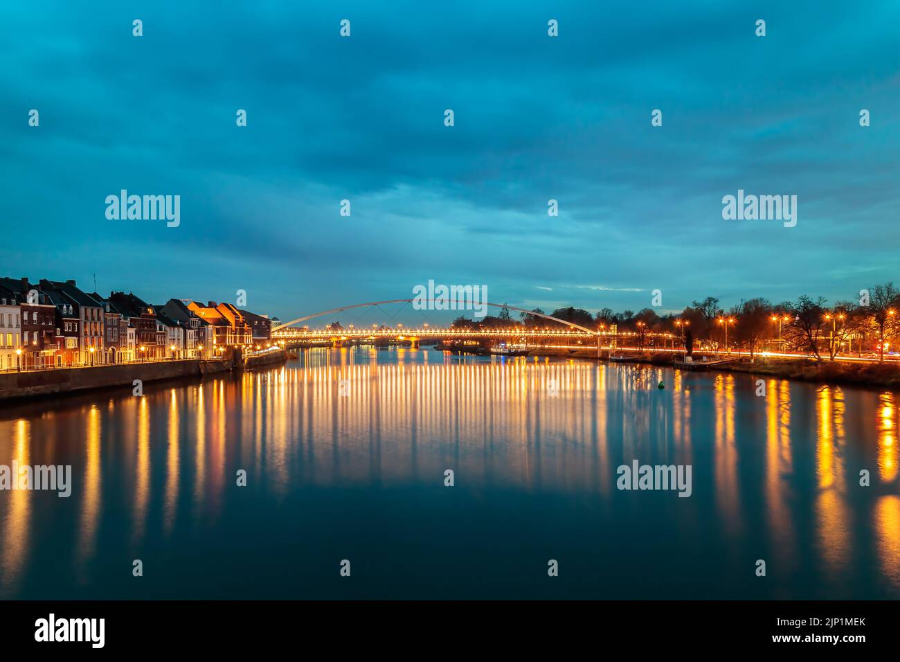 Evening view at the Maas river in the Dutch city of Maastricht with christmas lights reflecting in the water Stock Photo
