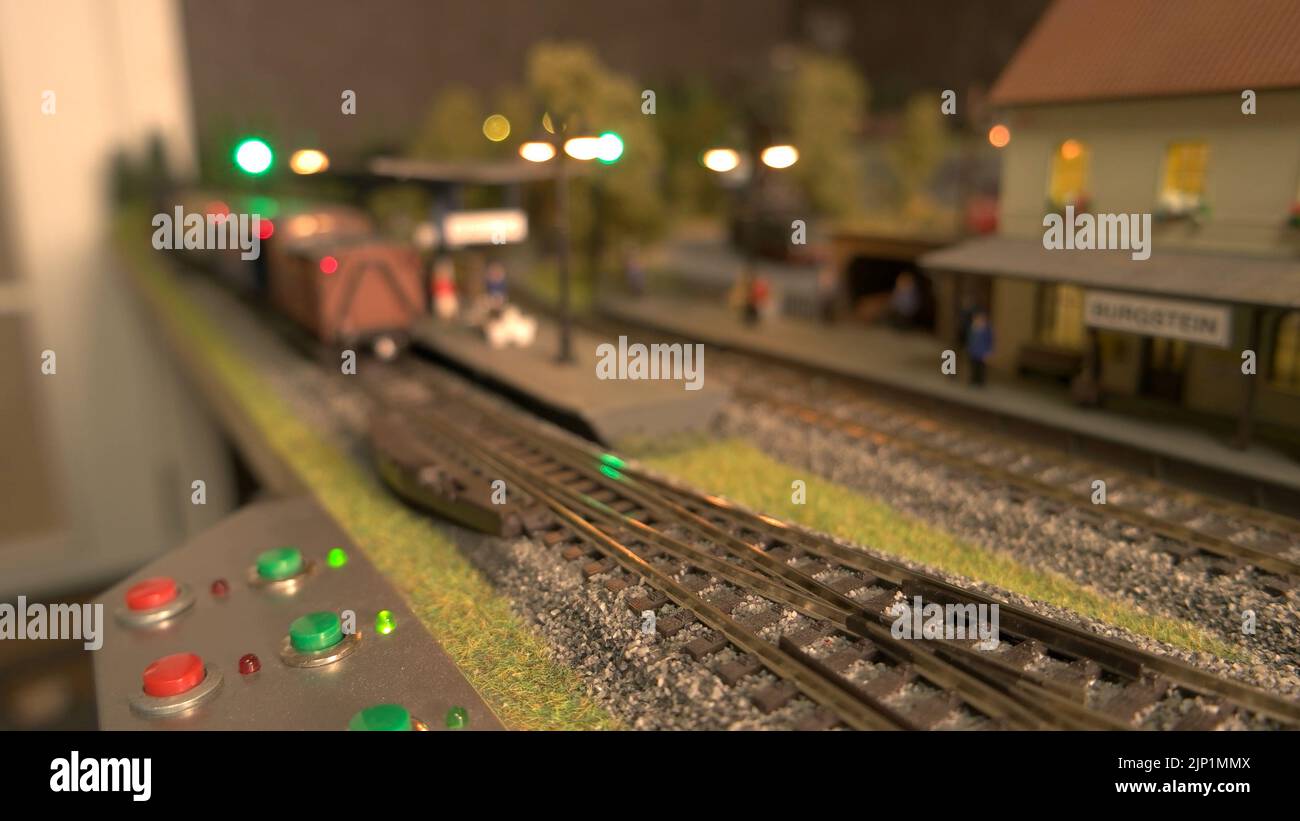 Model steam passing through station. Mini passenger train