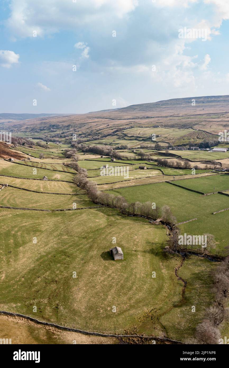 Stone barns and walls in farmland between Angram and Thwaite in Swaledale North Yorkshire high elevated view Stock Photo