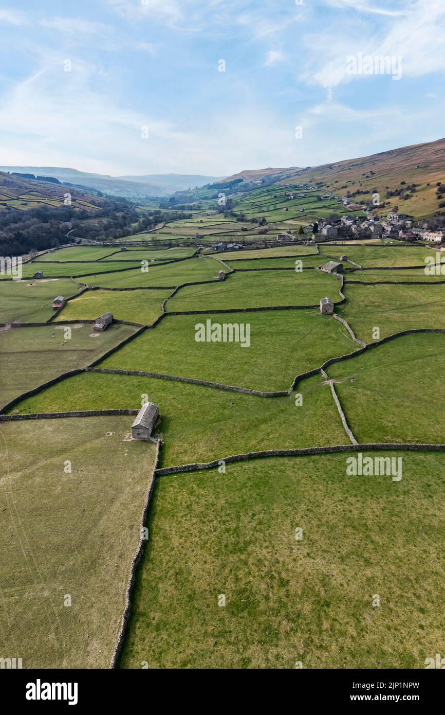 elevated vertical panoramic view of patchwork fields and traditional stone barns at gunnerside in swaledale north yorkshire Stock Photo