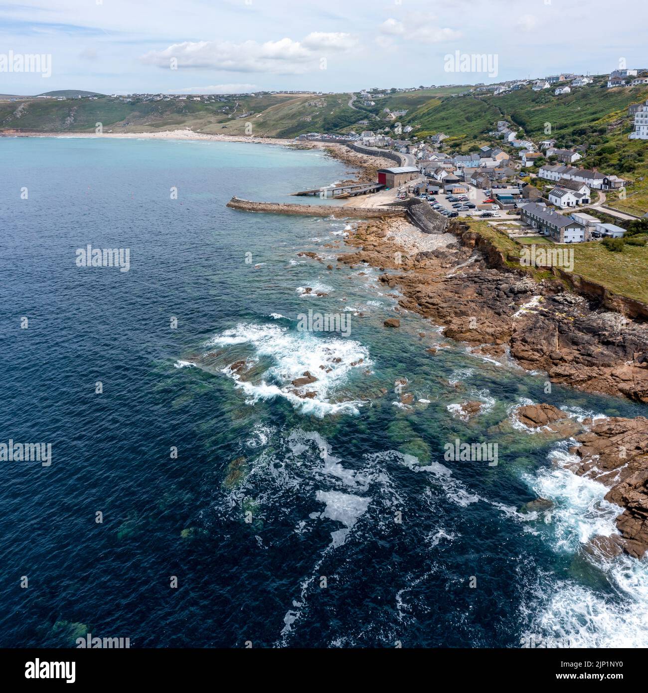 sennen cove cornwall showing rocky shore beach village and lifeboat station elevated view square format Stock Photo