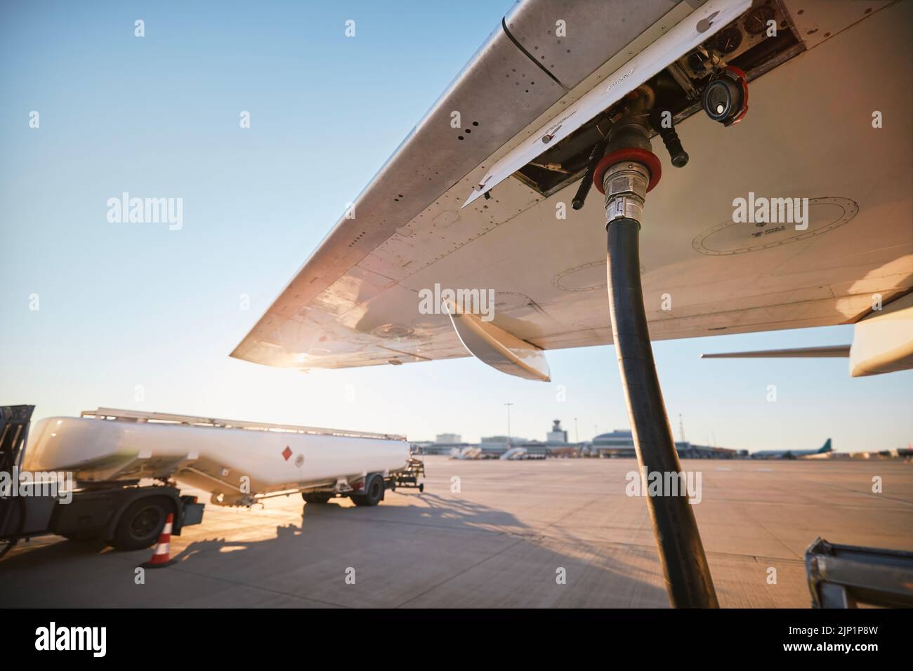 Refueling of airplane at airport. Ground service before flight. Stock Photo