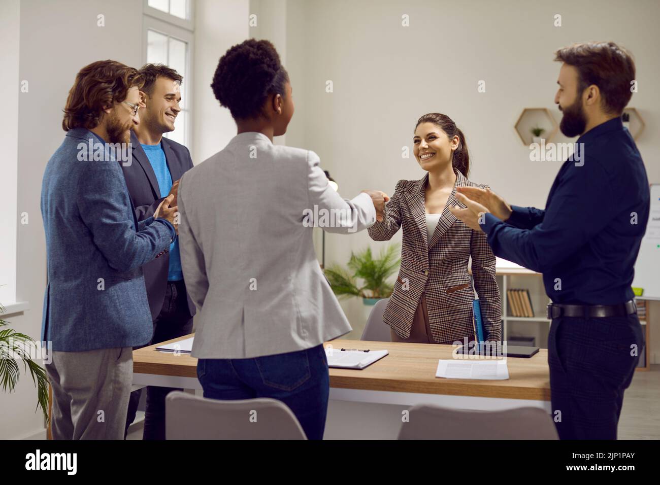 Teams of happy diverse people meet in the office and make a successful business deal Stock Photo