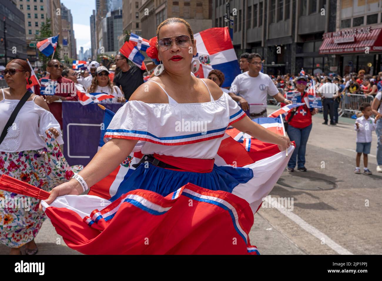 New York, United States. 14th Aug, 2022. Participants dance and march at the Dominican Day Parade on 6th Avenue in New York City. The National Dominican Day Parade celebrated 40 years of marching on Sixth Avenue in Manhattan. The parade celebrates Dominican culture, folklore, and traditions. Credit: SOPA Images Limited/Alamy Live News Stock Photo