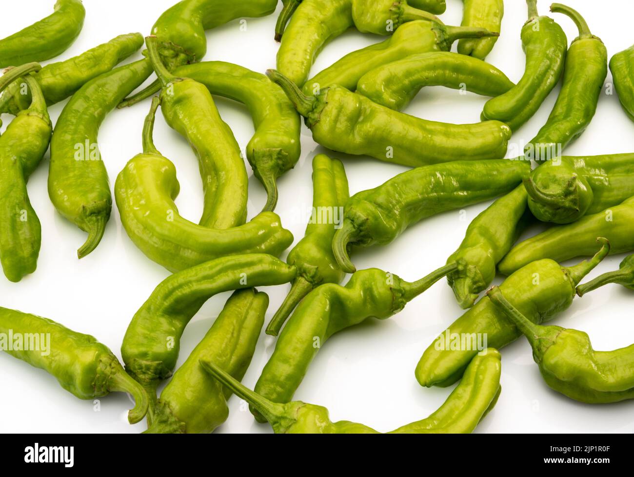 Friggitelli, Tuscan or Greek mild peppers, called also Pepperoncini in isolated on yellow background in top view Stock Photo