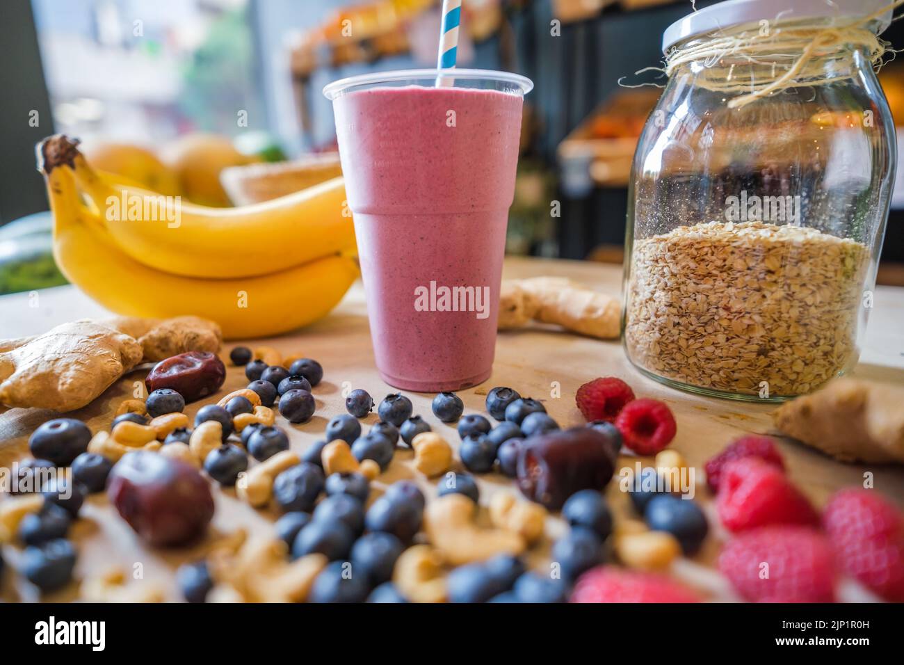 Healthy protein shake on table with fruits and vegetables ingredients