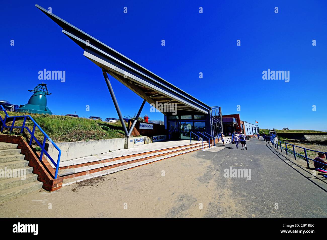 Newbiggin by the sea Northumberland beautiful seaside village with the Newbiggin Maritime Centre and cafe by the long promenade and beach against a de Stock Photo