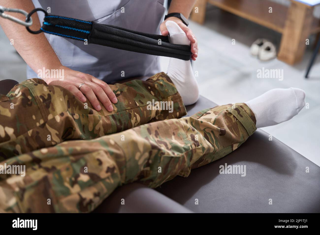 Physiotherapist works with the patient foot on a special simulator Stock Photo