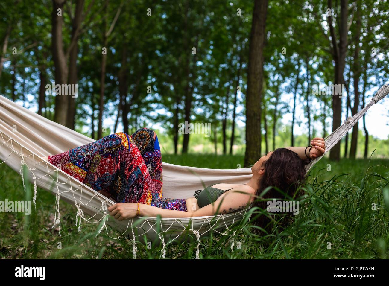 Beautiful young woman relaxing on hammock in the forest Stock Photo - Alamy