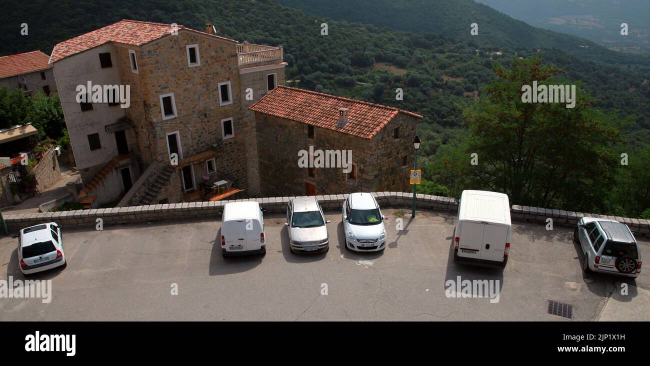 Olmeto, France - August 25, 2018: Street view with parked cars near Church of Santa Maria Assunta of Olmeto, Corse-du-Sud department of France on the Stock Photo