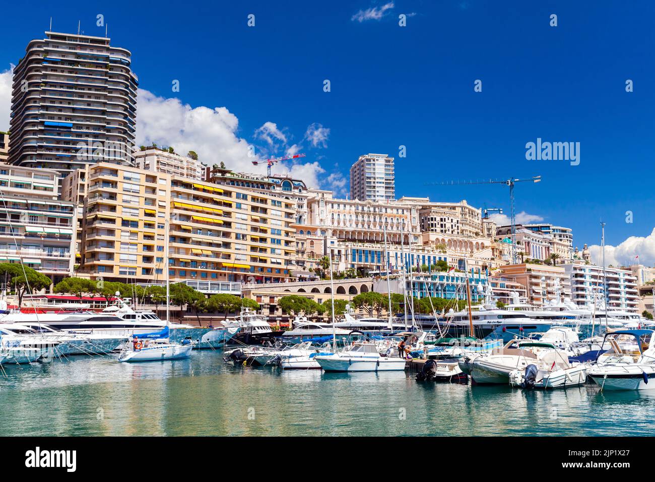 Monte Carlo, Monaco - August 15, 2018: Port Hercule photo taken on a sunny summer day. Yachts and pleasure boats are moored in marina Stock Photo