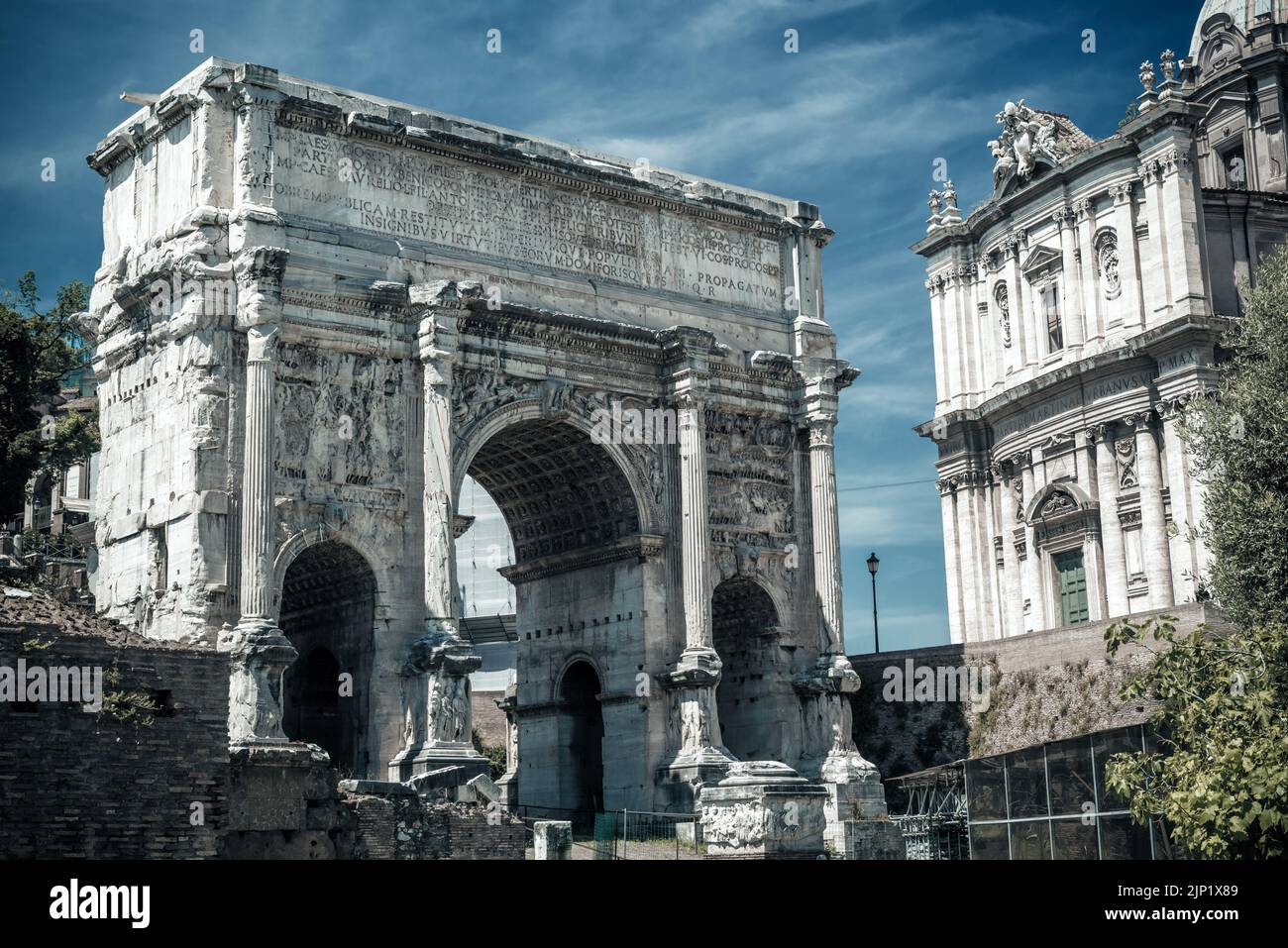 Roman Forum in Rome, Italy. View of Arch of Septimius Severus, Ancient monument and historic landmark of Rome. Scenery of old buildings in Roma city c Stock Photo
