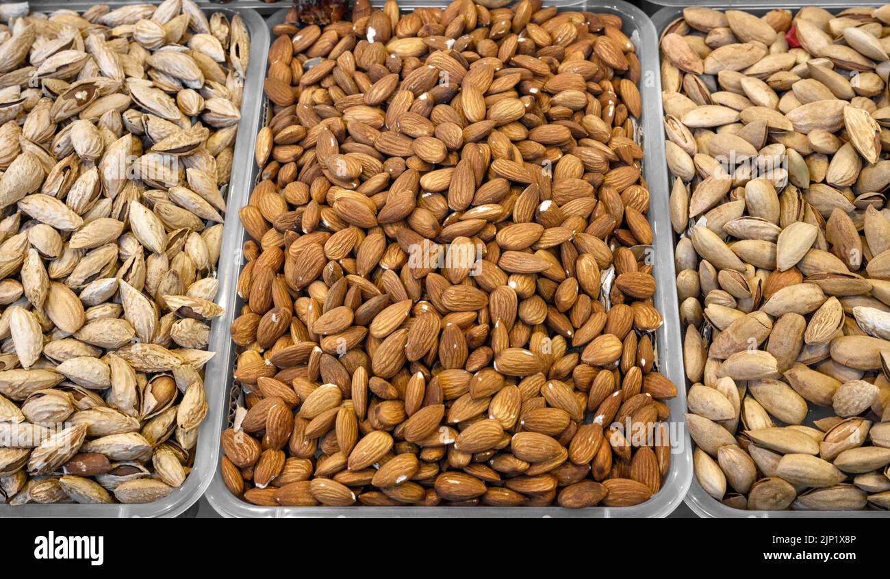 Almond peeled and unpeeled, nuts sales in market. Dry food, variety
