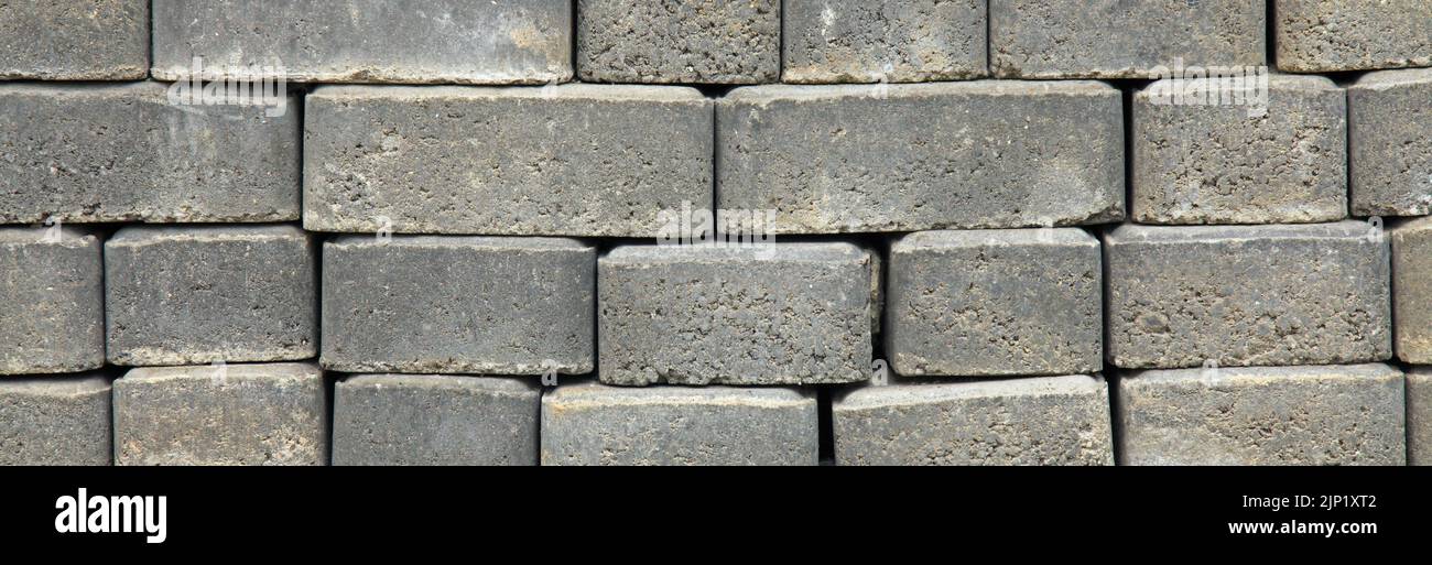 Regular shape blocks, texture, background. Paving slabs of gray blocks of flat shape, panorama. Pavement blocks in city park Stock Photo