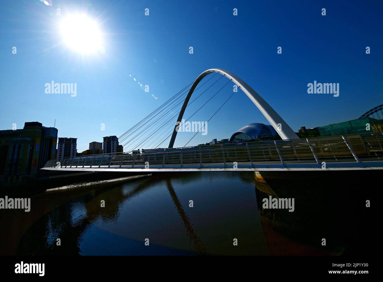 Gateshead Millenium Bridge against deep blue sky and star shaped sun Stock Photo