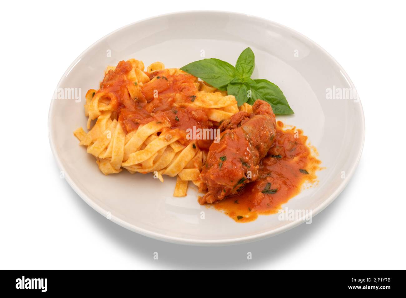Egg pasta tagliatelle with tomato sauce and beef meat roll in white plate, typical recipe from Puglia, Italy, called braciola al sugo. isolated on whi Stock Photo