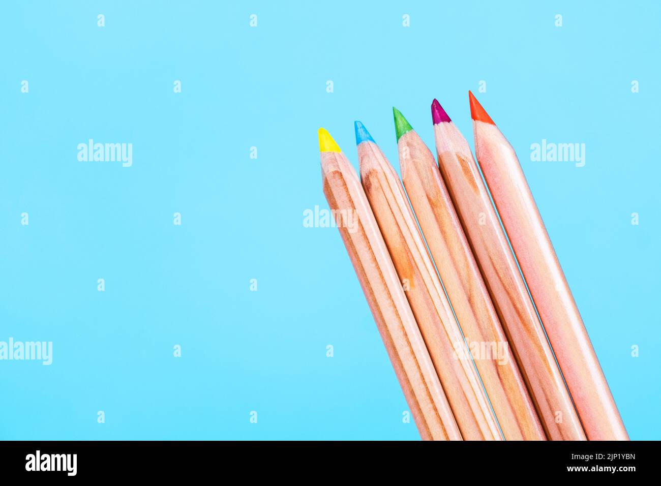 colored pencils made of wood on blue background. Copy space Stock Photo