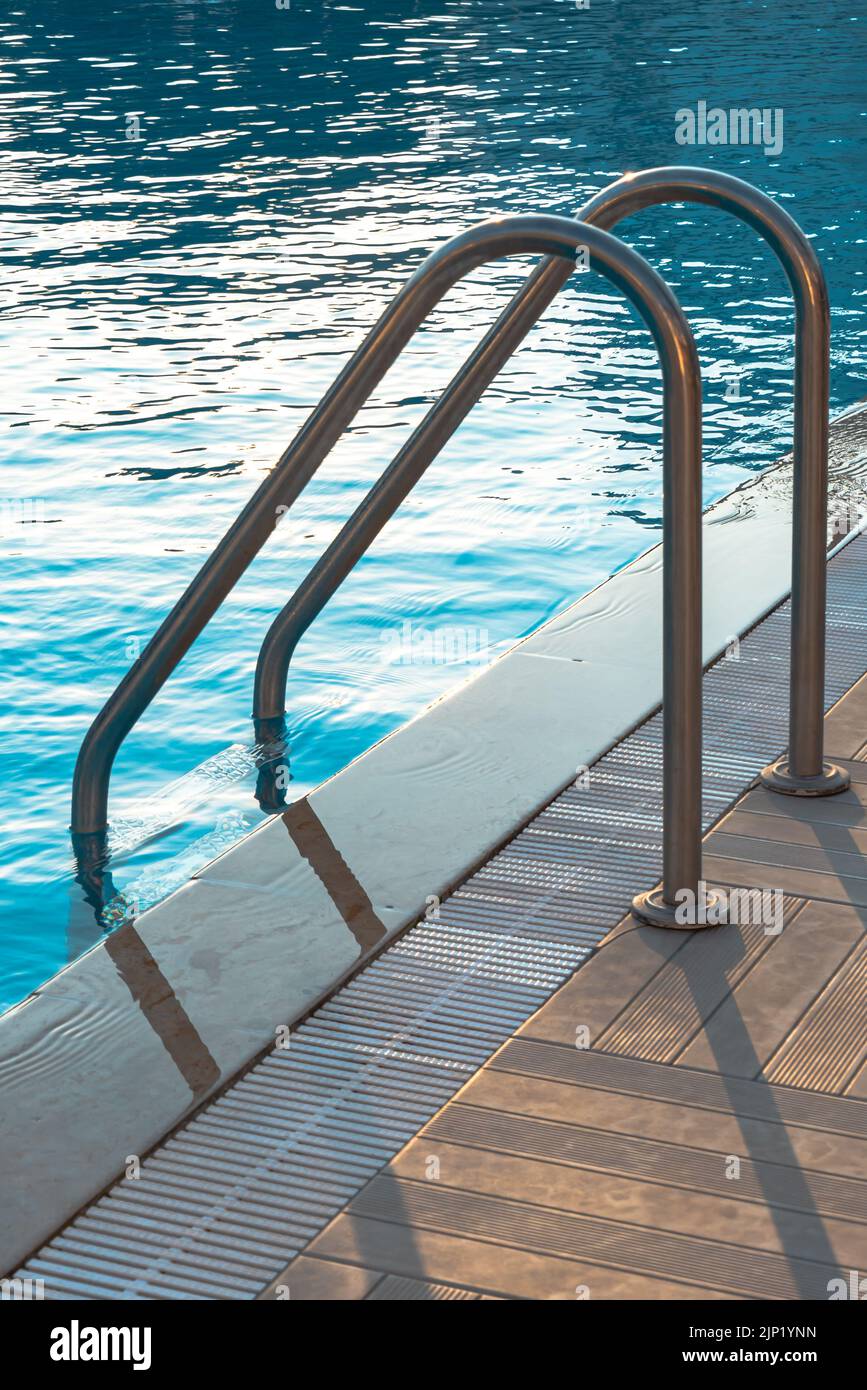 Fresh Look at Swimming Pool With Stair And Wooden Deck At Hotel Stock