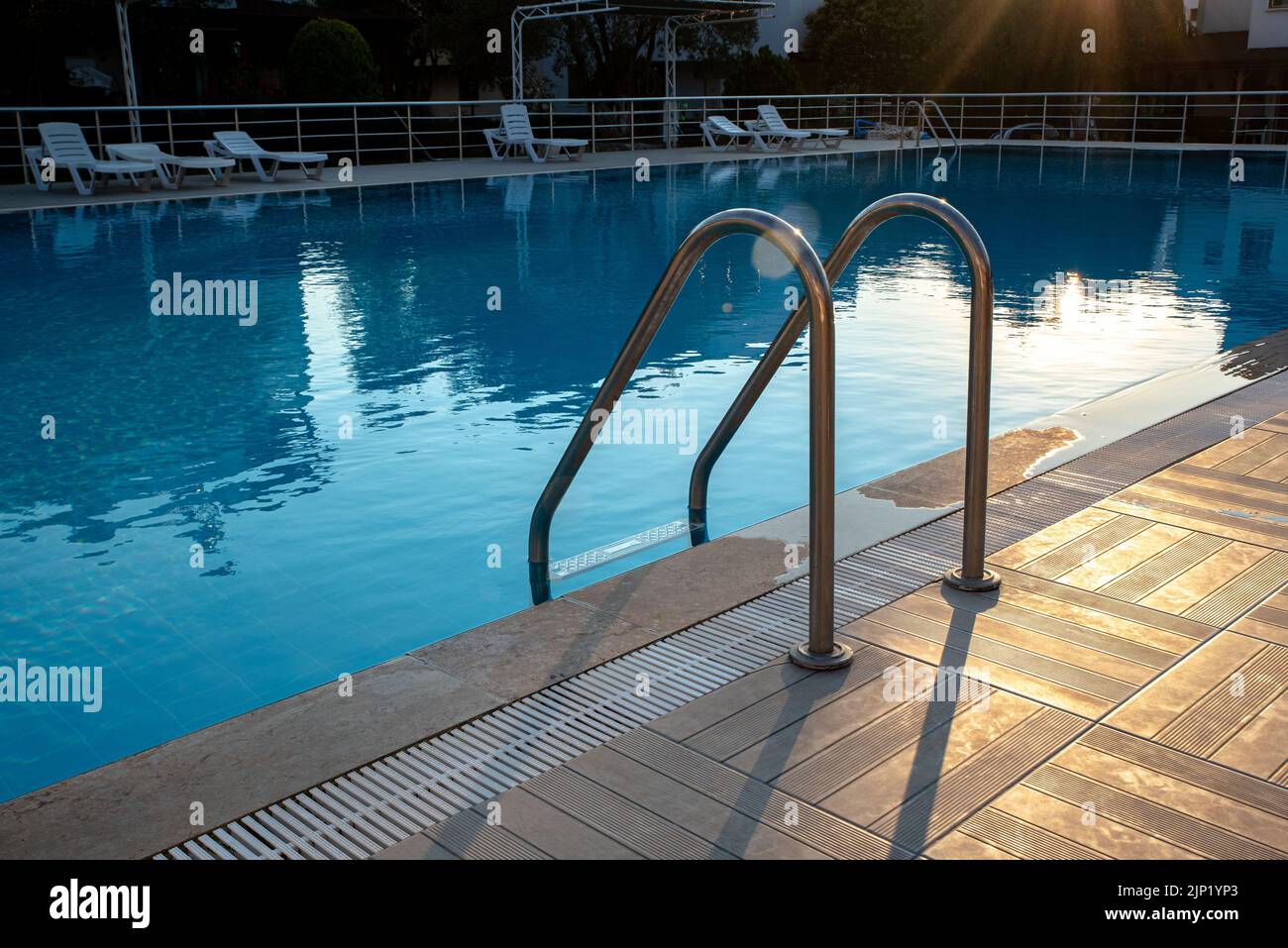 Swimming pool with stair and wooden deck at hotel Stock Photo - Alamy