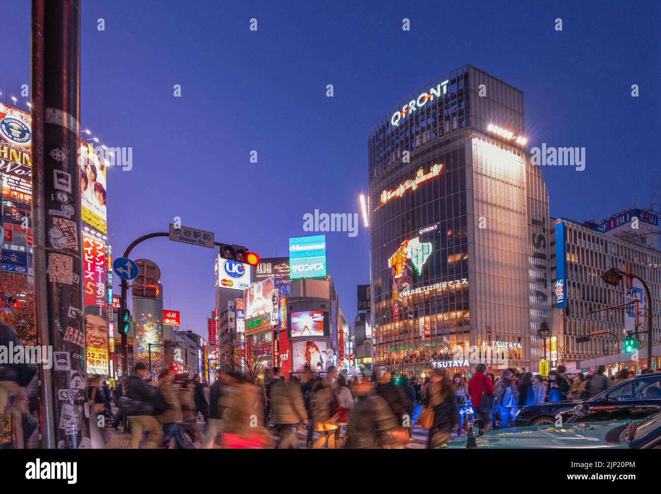 DECEMBER 24, 2012 - TOKYO, JAPAN: Pedestrians cross Shibuya Crossing, one of the busiest crosswalks in the world. Stock Photo