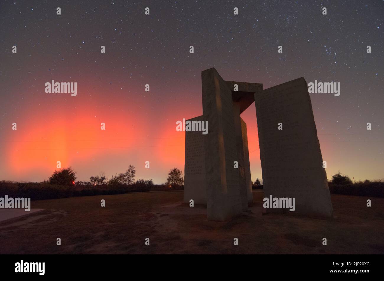 A rare Aurora Borealis behind the Georgia Guidestones in Elberton, Georgia, USA. Stock Photo