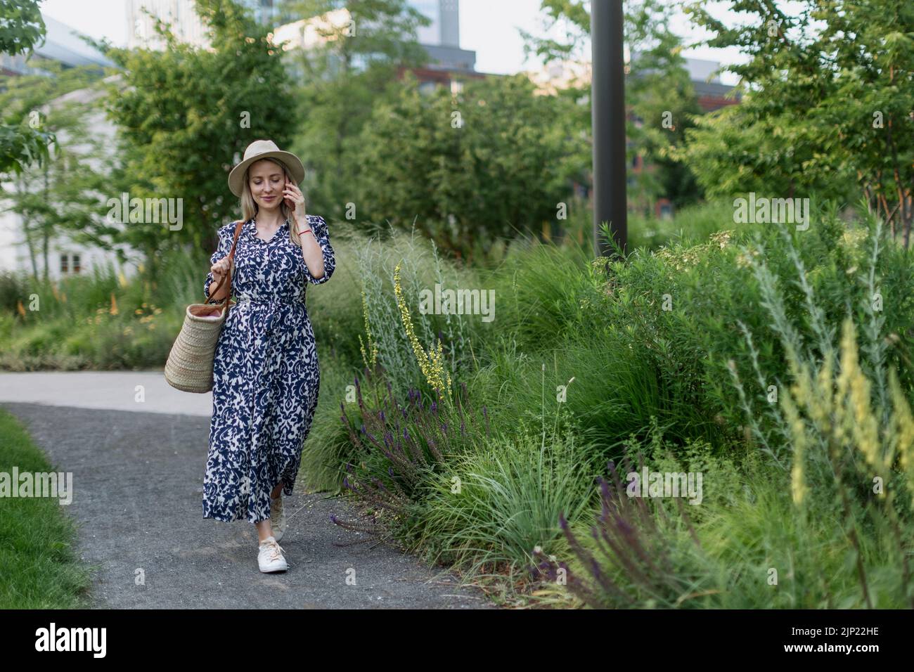 Mature woman alone walking park hi-res stock photography and images - Alamy