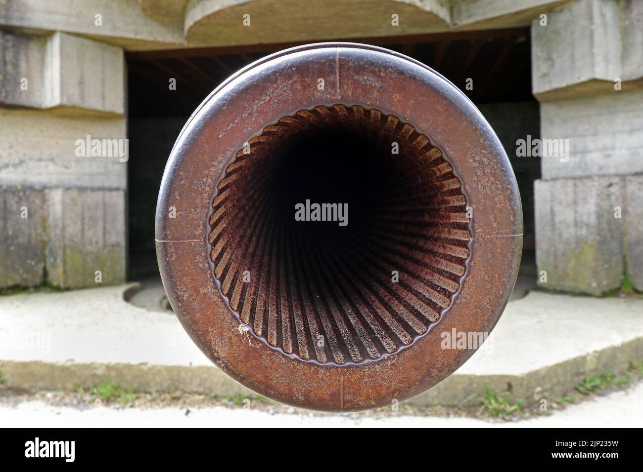 The view down the muzzle of a 150mm Calibre TbtsK C/36 Marine Gun which shows the Rifling at the Longues-sur-Mer battery, Normandy, France. Stock Photo