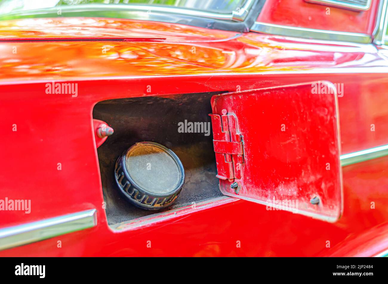 Open fuel tank of Lada car. Car refueling closeup. Old red car Stock