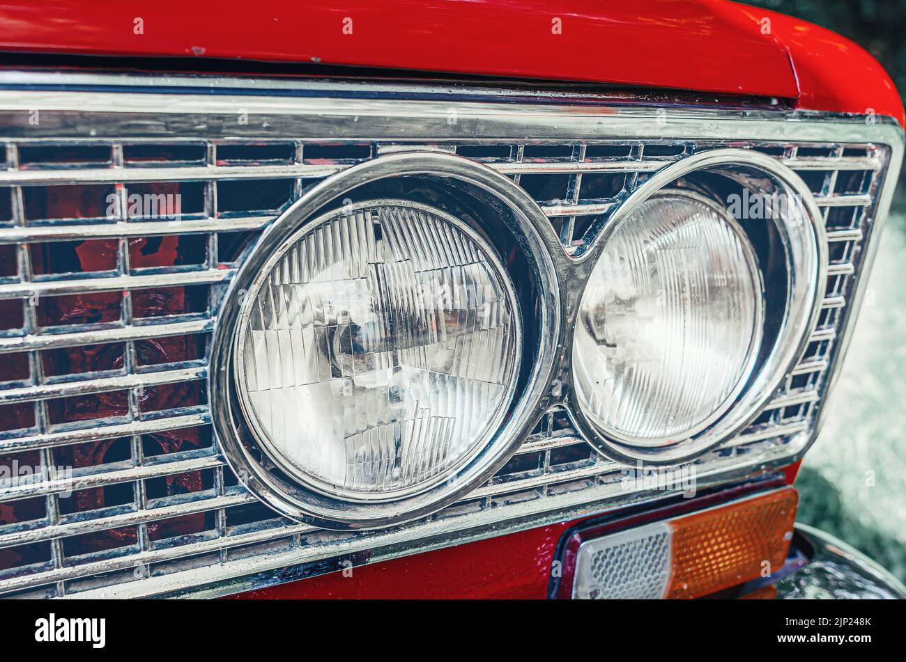 Headlights of red car close-up. Front of old red Lada car. Stock Photo