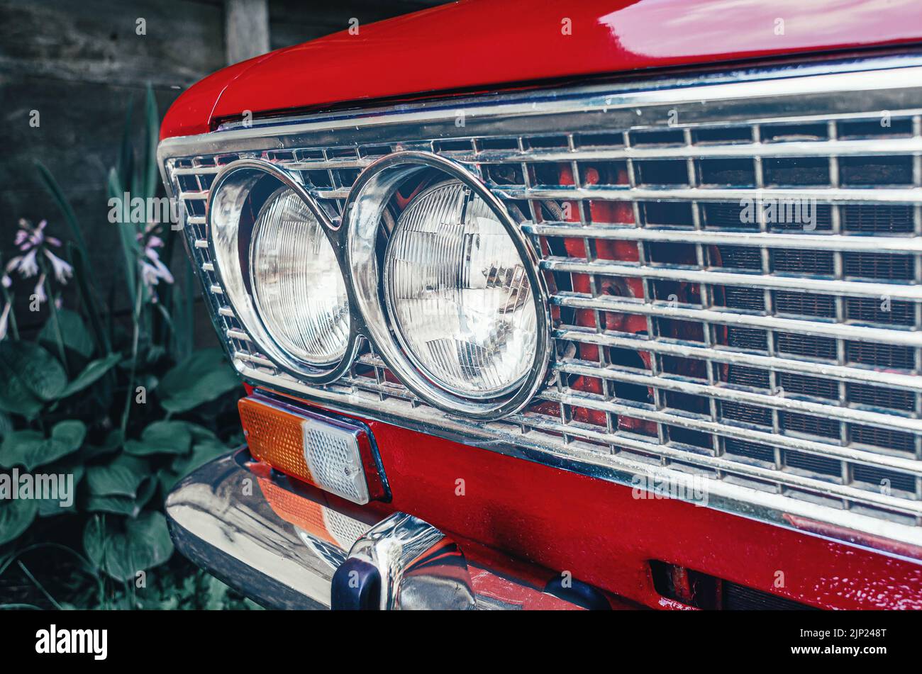 Headlights of red car close-up. Front of old red Lada car. Blurred background Stock Photo