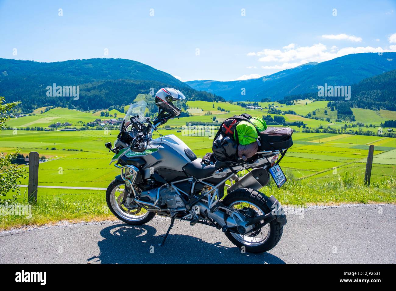Dolomites Italy - July 2, 2022: Motorcycle with full equipment on the side of a rural mountain alpine road in area of Dolomites, Italy Stock Photo