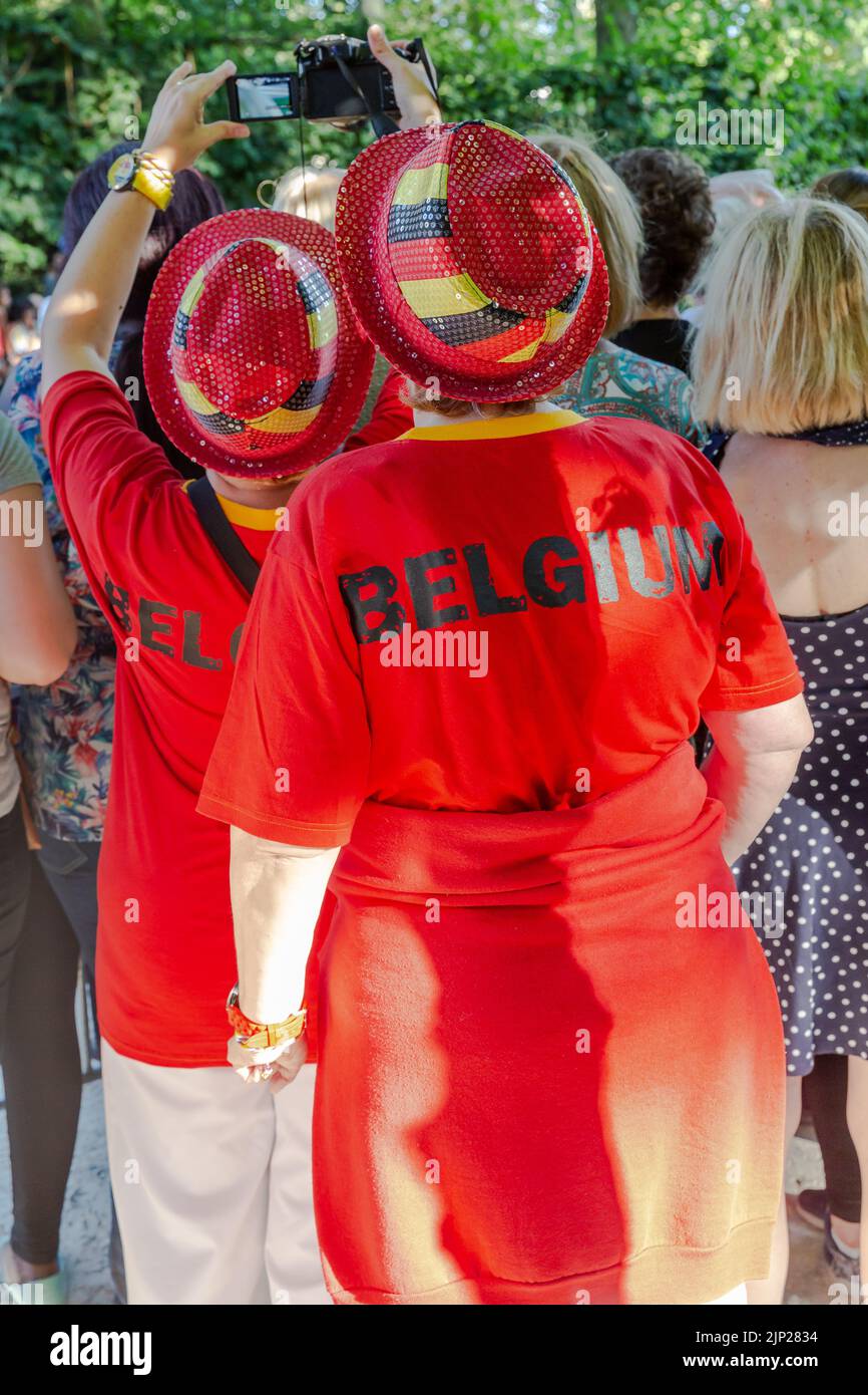 Two ladies dressed in the national colors of Belgium attended the passage of the king in the Parc de Bruxelles Stock Photo