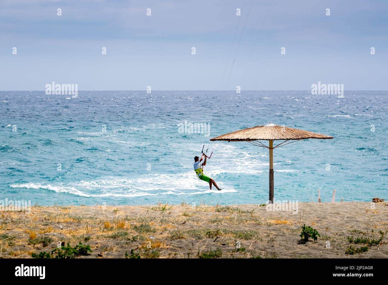 Man kitesurfing in Agiokampos beach of Aegean sea,Greece Stock Photo