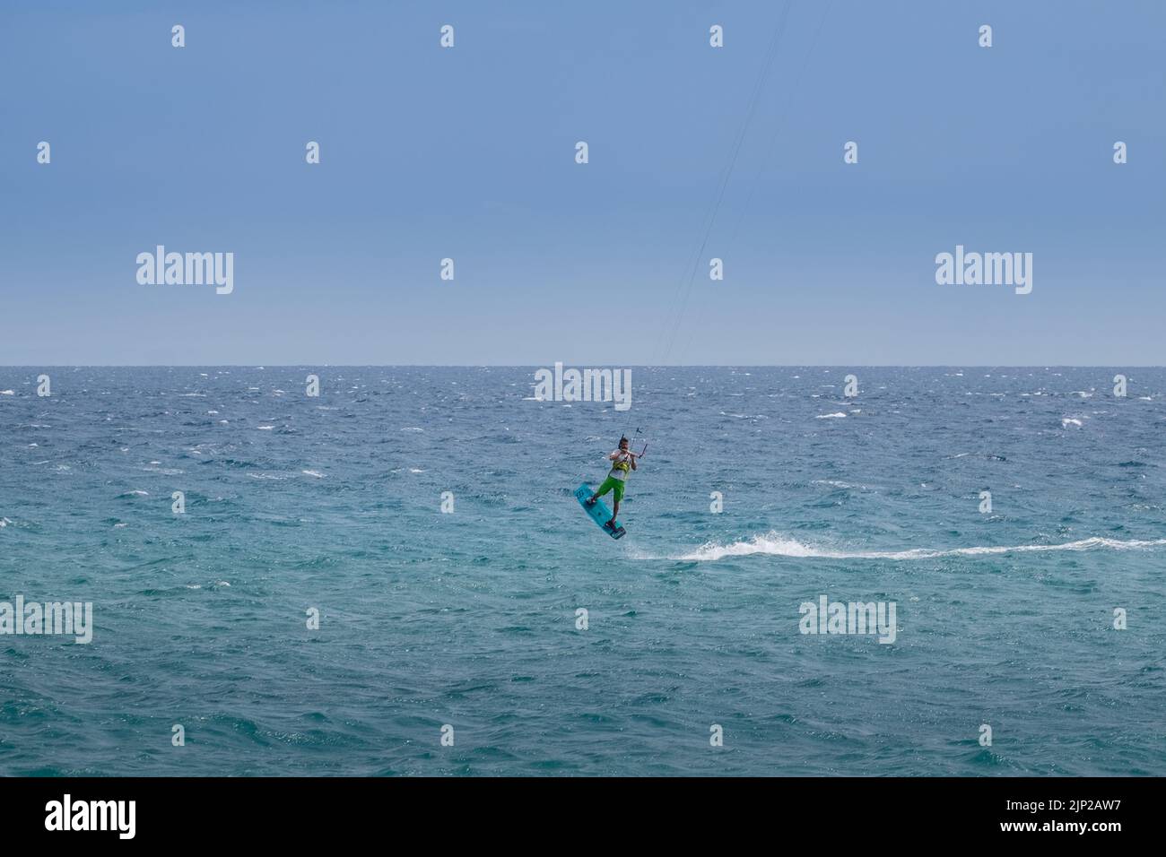 Man kitesurfing and jumping in Agiokampos beach of Aegean sea,Greece Stock Photo