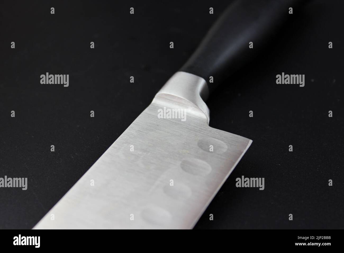 Kitchen utensils on black background. Cutting sharp knife Stock Photo