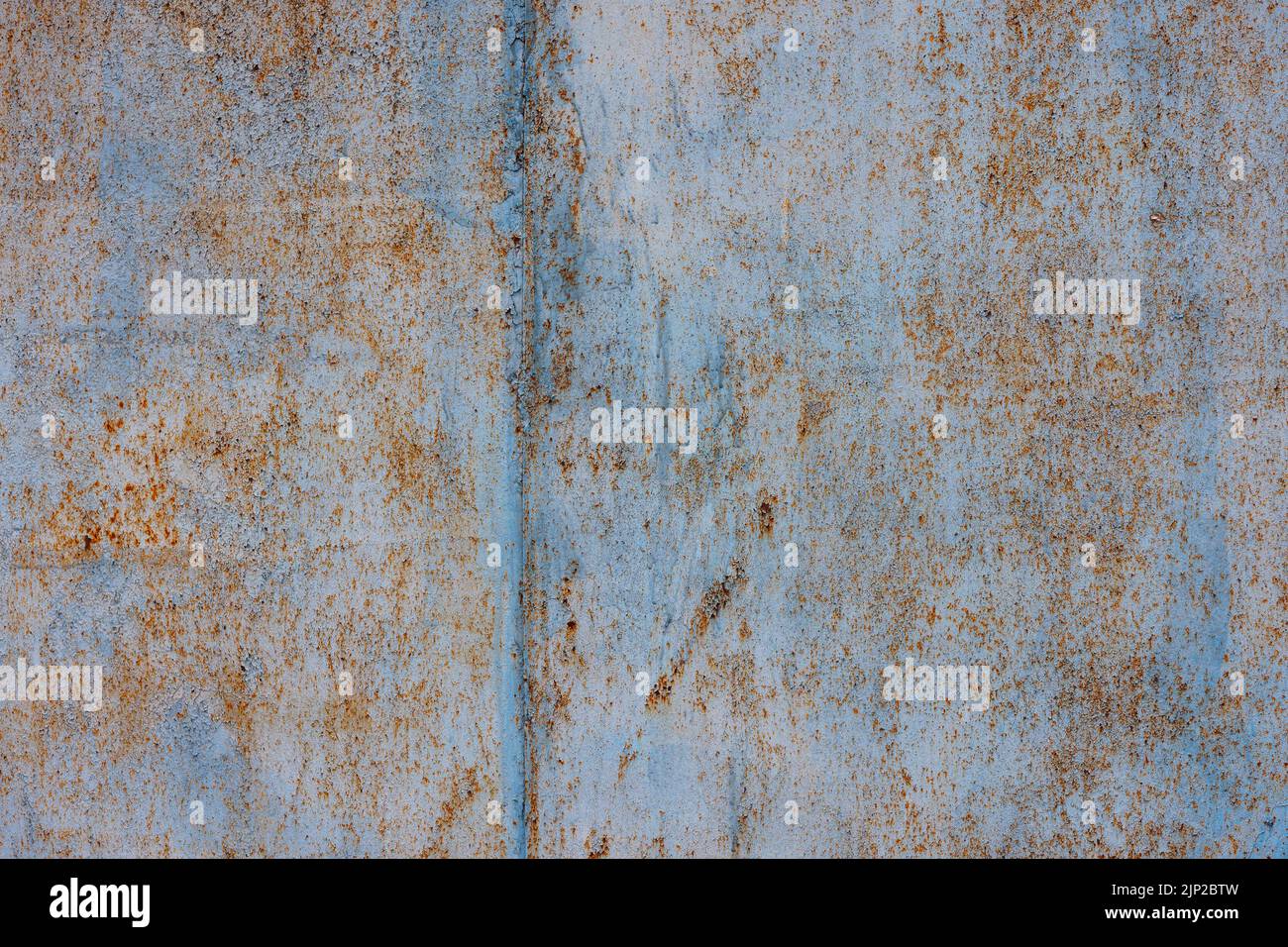 rough light-blue peeling paint on rusted flat sheet metal surface Stock Photo