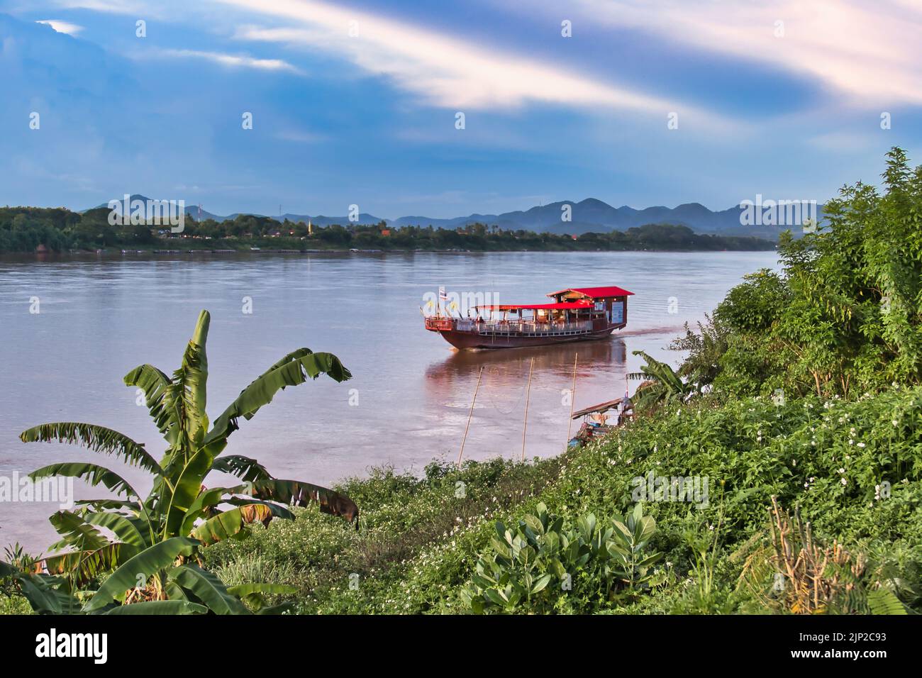 Restaurant boat on the Mekong River at Chiang Khan, province of Loei, Thailand. On the other side of the river is Laos. Stock Photo