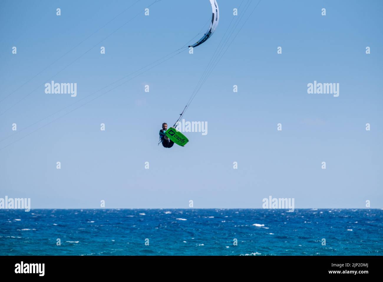 Man kitesurfing and jumping in the air at the Beach of Agiokampos, Greece Stock Photo