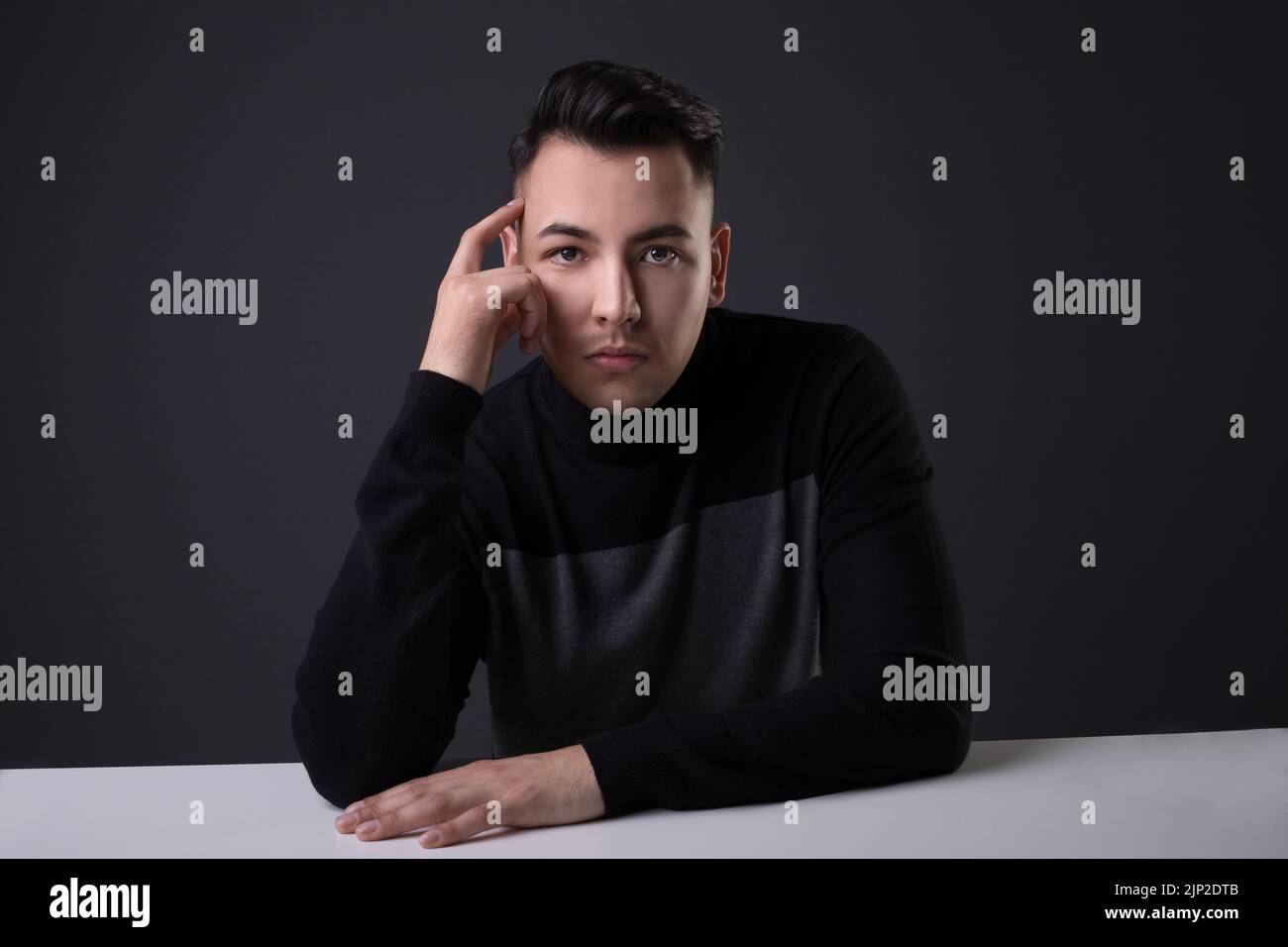 A handsome male in a studio thinking about something Stock Photo
